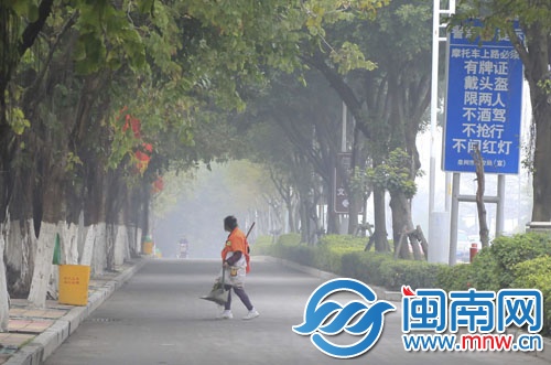 一名環衛工在霧中清掃