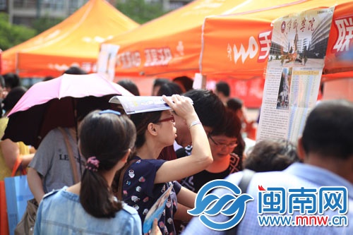 海都咨詢會現場，一名家長頂著烈日看學校信息